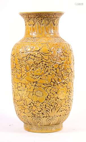 A Chinese yellow ground vase with all over relief foliate decoration, impressed seal mark to