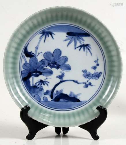 A Japanese Arita blue & white plate decorated with flowers and bamboo with six-character mark to