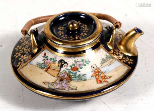 A Japanese Meiji period miniature teapot decorated with figures within a landscape, with gilt