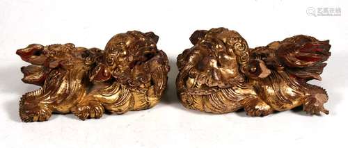 A pair of 19th century carved giltwood Chinese dogs of fo, 16cms (6.25ins) long.