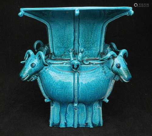 A Chinese archaic style turquoise glazed square form vase, with four rams to the corners, square