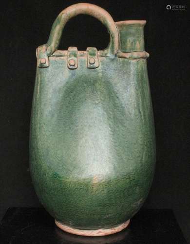 An early Chinese green glazed flask (restored), 33cms (13ins) high.