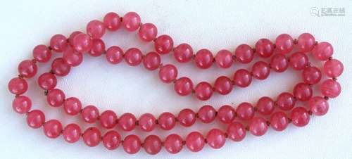 A Chinese pink glass bead necklace.