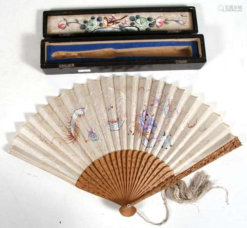 A Chinese carved sandalwood fan with embroidered decoration depicting a dragon chasing a flaming