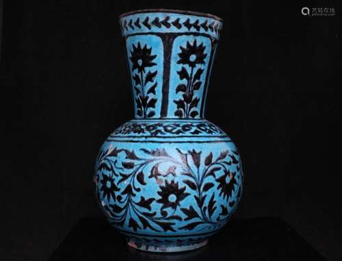 A 19th century Persian Iznik vase decorated with flowers on a turquoise ground with script mark to