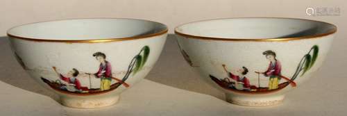 A pair of Chinese Qing dynasty tea bowls decorated with figures in boats on a sgraffito decorated