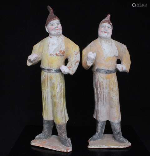 A pair of Chinese polychrome terracotta foreigner figures, the largest 31cms (12.25ins) high (2).