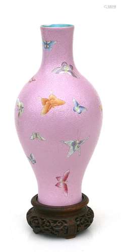 A Chinese vase decorated with butterflies on a pink sgraffito decorated ground, red seal mark to