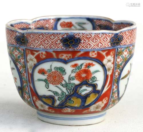 A 19th century Japanese Imari cup decorated with flowers within panels, four character blue mark