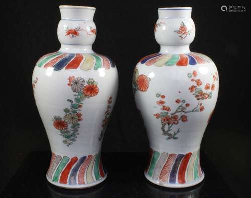 A pair of Chinese Kangxi famille rose vases decorated with flowers, 24cms (9.5ins) high.Condition