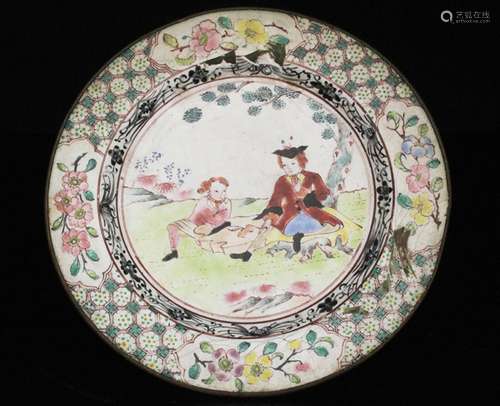 An 18th century Chinese enamel dish decorated with European figures within a foliate border,