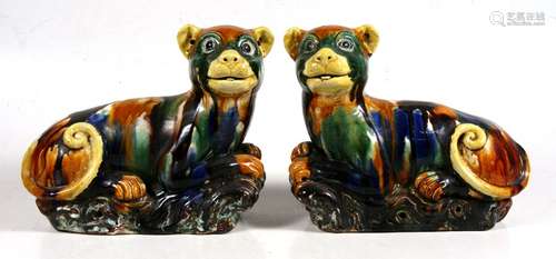 A pair of Chinese sancai glazed models of recumbent dogs, purported to be from Little Sodbury Manor,