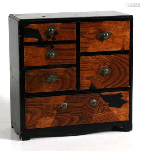 A Japanese parquetry inlaid miniature table top chest with five short and one long drawer, 20cms (