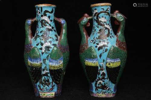 A pair of 19th century Chinese two-handled vases decorated with dragons and flowers on a turquoise