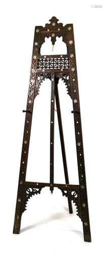 An Islamic carved hardwood easel inlaid with mother of pearl and ivory decoration, 170cms (67ins)