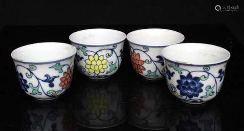 A set of four Chinese Doucai porcelain cups decorated with flowers in foliage, 4cms (1.5ins) high.