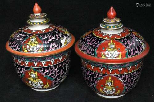 A pair of Thai Bencharong bowls & covers, decorated with figures on a black ground, 16cms (6.