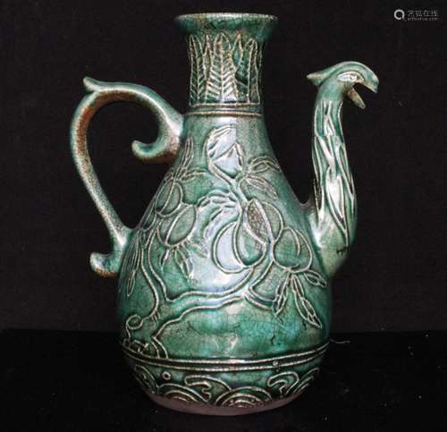 A Chinese green crackle glazed wine pot or ewer decorated with fruit and a phoenix spout, 19cms (7.