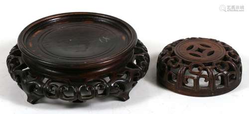 A Chinese pierced hardwood vase stand, 14cms (5.5ins) diameter; together with a pierced hardwood