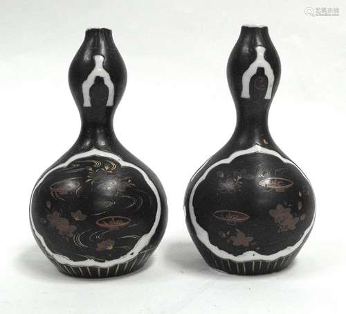 A pair of 19th century Chinese double gourd vases with gilt decoration on a black ground, 18cms (