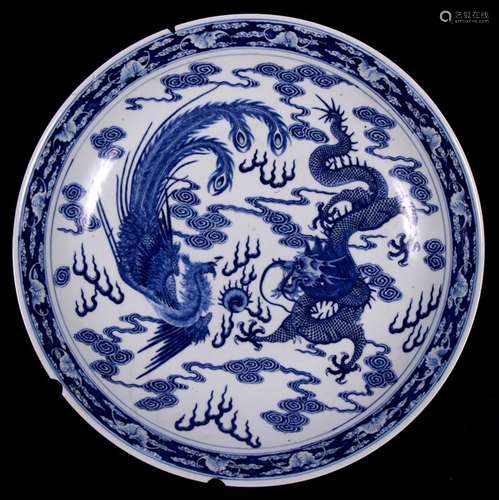 A Chinese blue & white charger decorated with a phoenix and dragon chasing a flaming pearl amongst