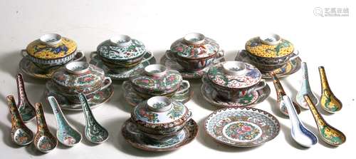 A set of eight assorted pattern Chinese famille rose twin-handled soup cups on stands, with matching