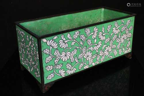 A Chinese cloisonne enamel planter decorated with flowers on a green ground, 24cms (9.5ins) wide.