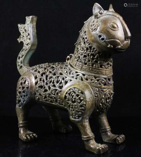 A Persian reticulated bronze incense burner in the form of a cat, 18cms (7ins) high.