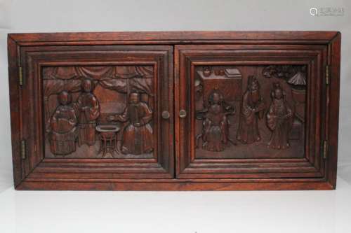 A Chinese hardwood scholars cabinet with carved figural panels, 42cms (16.5ins) wide.