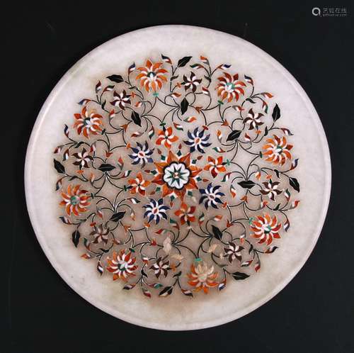 An Indian pietra dura style circular panel inlaid with semi precious stones, 28cms (11ins) wide.