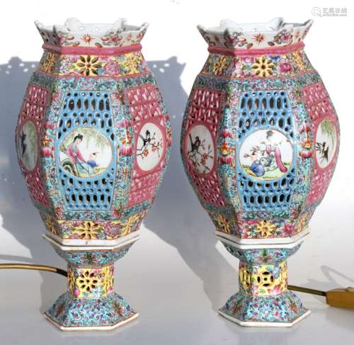 A pair of Chinese pierced table lamps of hexagonal form with panels decorated with birds and