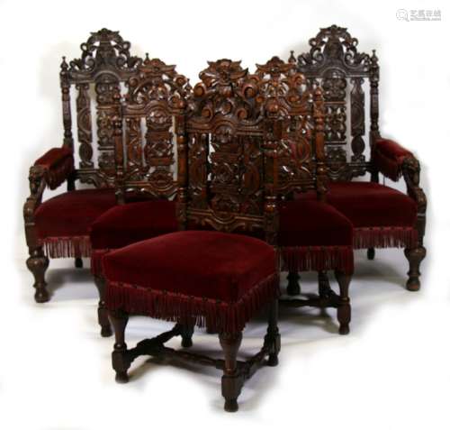 A set of twelve Victorian oak dining chairs with carved and pierced backs and upholstered seats,