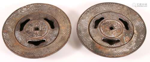 A pair of cast iron shallow incense burners with pierced covers, 18cms (7ins) diameter.