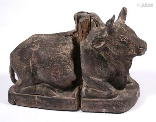 An 18th / 19th century Indian carved hardwood Nandi bull statue, 41cms (16ins) wide.