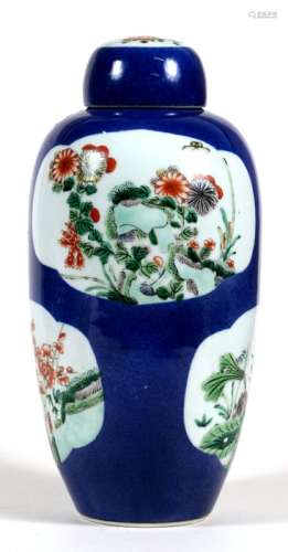 A Chinese vase and cover decorated flowers and foliage within panel on a powder blue ground,