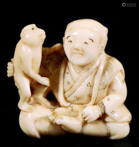 A Japanese carved ivory netsuke in the form of a man with a pet monkey, signed 'Shunshi' to the