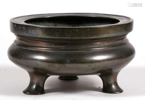 A Chinese bronze tripod censer with six-character mark to underside 16cms (6.25ins) diameter.