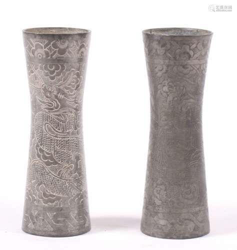 A pair of Chinese pewter vases engraved with dragons and flowers, 11cms (4.25ins) high (2).