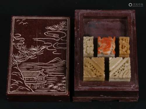A Chinese soapstone box containing five carved soapstone seals, 7.5cms (3ins) wide.