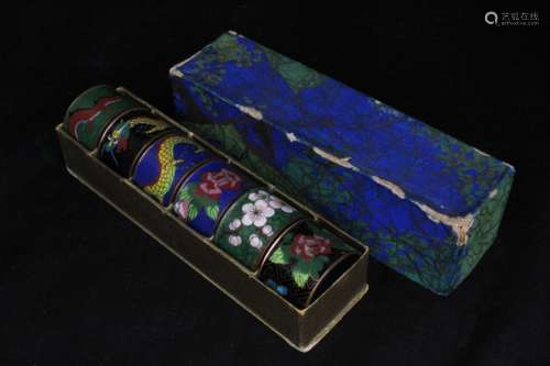 A boxed set of six early 20th century Chinese cloisonne enamel napkin rings decorated with dragons &
