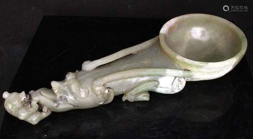 A Chinese carved jade or hardstone scoop, the handle in the form of a dragon with a bear, 28cms (