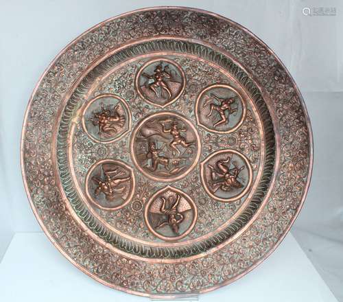 A 19th century Indian repousse copper tray with roundels depicting various deities within a