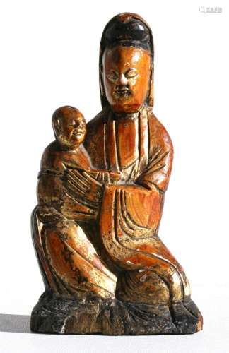 An 18th / 19th century Chinese carved gilt wood group depicting a robed woman holding a child,