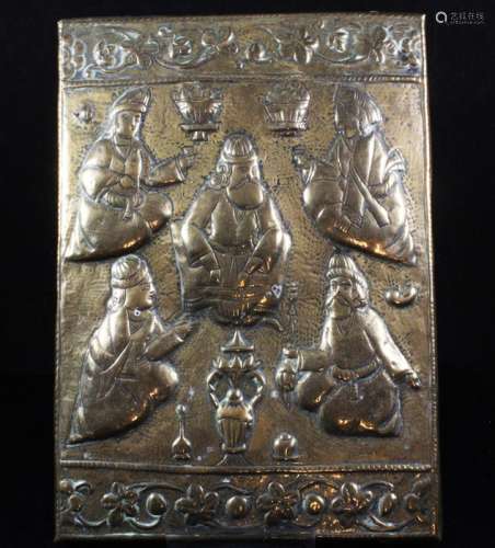 A Persian Qajar brass on wood plaque depicting seated noblemen, 16 by 23cms (6.25 by 9ins).