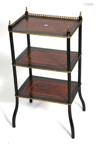 A French ebonised three-tier etagere with pierced brass gallery, 42cms (16.5ins) wide.