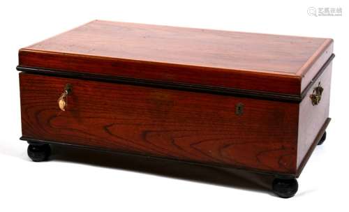 A teak trunk with brass carrying handles, on turned feet, 100cms (39.25ins) wide.
