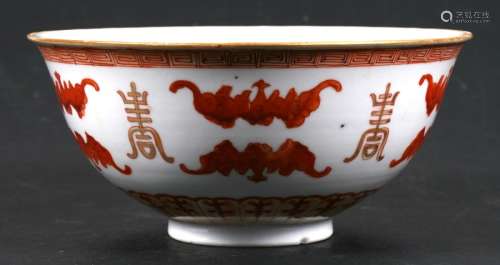 A Chinese footed bowl decorated iron red bats and symbols, having a blue six character mark to the