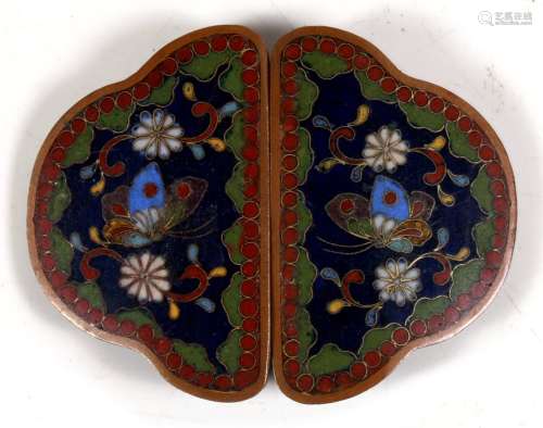 A Japanese cloisonne buckle decorated with flowers and butterflies on a deep blue ground, 7.5cms (