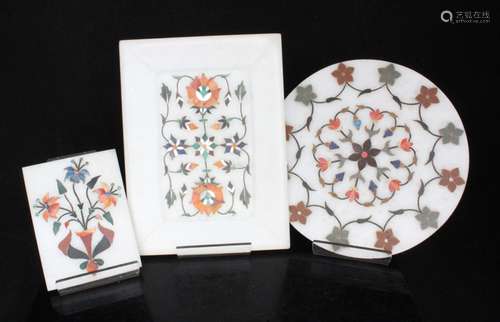 Three Indian pietra dura style panel inlaid with semi precious stones, the largest 17.5cms (7ins)