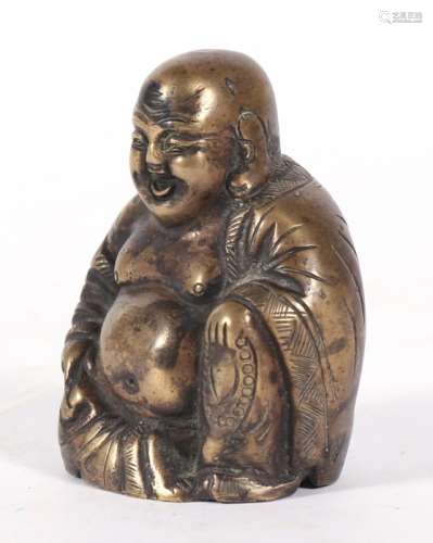 A Chinese bronze figure in the form of a seated Buddha, 8cms (3.1ins) high.